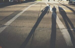 Shadow of three people walking on the street