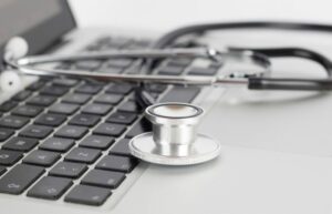 Stethoscope laying on a laptop keyboard