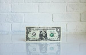 dollar bill sitting on white counter