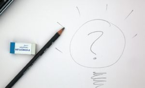 pencil with eraser drawing a question mark lightbulb