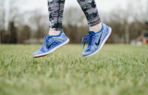 A person jumping in blue Nike shoes