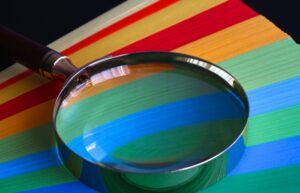magnifying glass ontop of colored paper