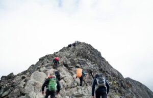 People summitting a mountain