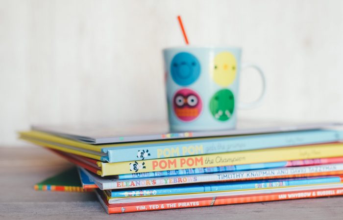 children's books with colorful mug on top