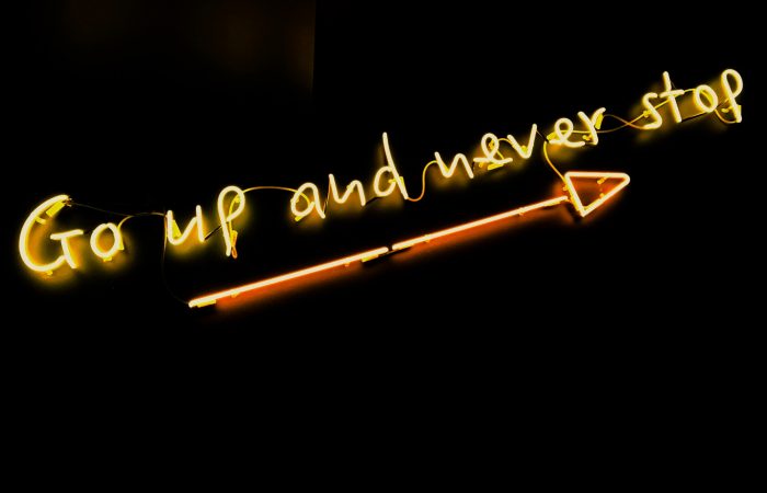 neon words "go up and never stop"